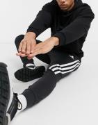 adidas - Sorte joggingbukser med 3-stribet sidebånd